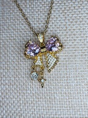 Gold Tone Bow Pendant Necklace with Pink Crystals